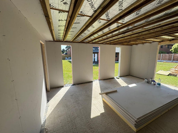 New extension shell with an insulated timber roof structure and openings out to the garden